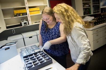 Art history professor Andrea Campbell and Sara Primm '20 look at glass samples from Randolph's archaeology collection
